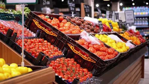 Tomatoes and Other Fresh Vegetables with Price Tags on Supermarket Shelves