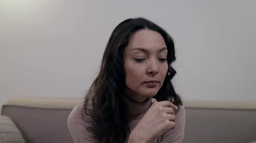 Sad Woman Sitting in Silence at Home