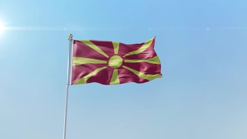 North Macedonia Flag Waving on Pole against Blue Sky