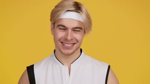Close Up of Smiling Young Man Against Yellow