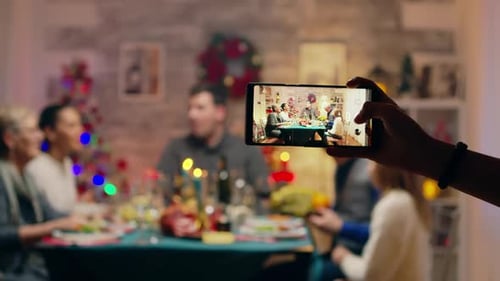 Family Gathering at Christmas Dinner Captured on Phone