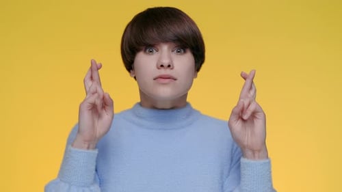 Portrait of Excited Caucasian Woman Crossing Fingers