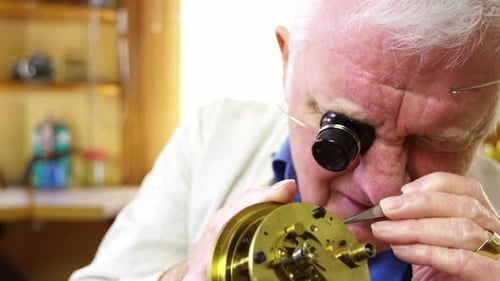 Watch Repairman Fixing a Clock Mechanism