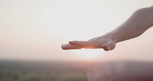 Team Hands Together at Golden Sunset