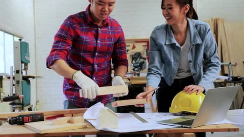 Team Works Together on Building Project in Workshop