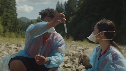 Scientists Analyzing Water Samples by Forest River