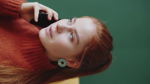 Young Woman Talking on Smartphone Indoors