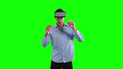 a Caucasian man wearing 3D goggles in a green background