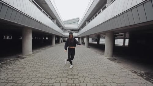 Energetic Woman Dancing in Urban Parking Garage