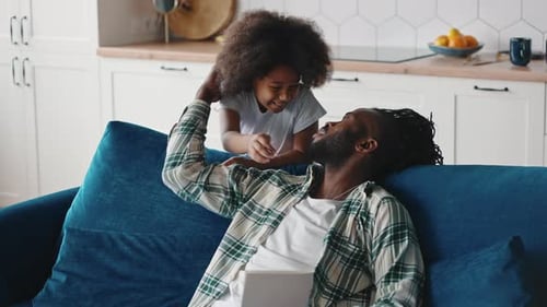 Loving Child Gives Handmade Card to Smiling Father