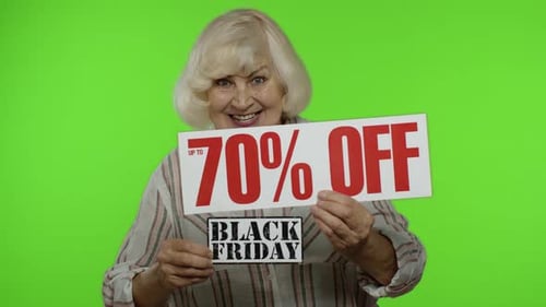 Senior Woman Holding 70% Off Sign on Green Screen