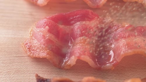 Seasoned Bacon Strips on a Wooden Board