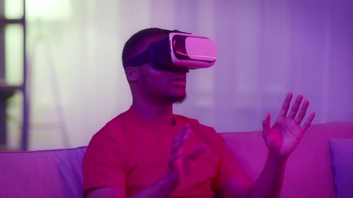 Adult Male Using Virtual Reality Headset at Home