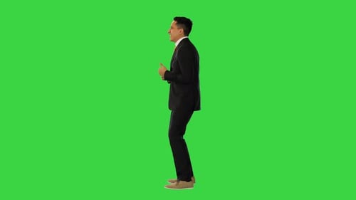 Cheerful and Happy Businessman Dancing on a Green Screen Chroma Key