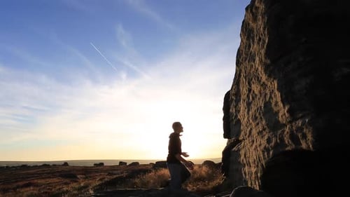Man Free Climbing at Sunset in Nature