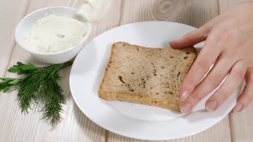 Spreading Cream Cheese on Whole Wheat Toast