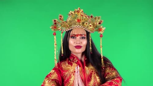 Portrait of Beautiful Woman Is Looking Straight and Dancing. Green Screen.