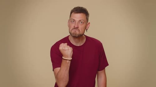 Aggressive Man Clenching Fists and Arguing