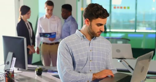 Male executive using laptop
