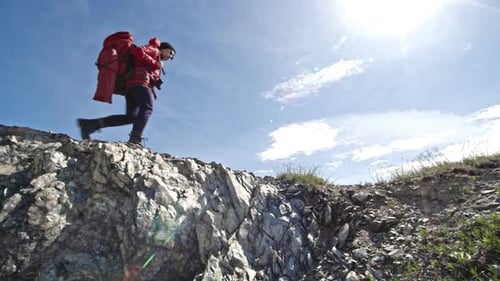Woman Hiker Walking Along Mountain Ridge