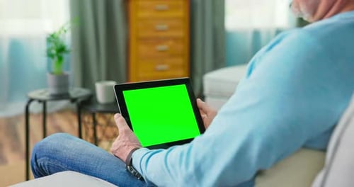 Adult Old Man at Home Watches Green Mockup Screen Tablet