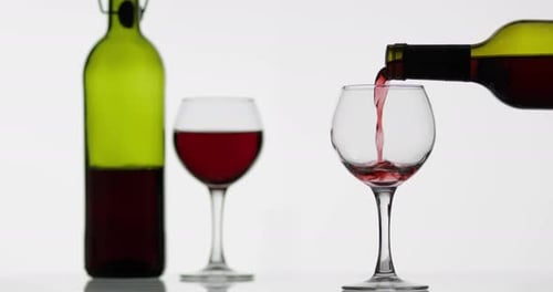 Rose Wine. Red Wine Pour in Wine Glass Over White Background