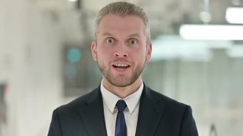 Portrait of Excited Young Businessman Celebrating Success