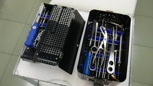 Surgical Instruments Neatly Arranged in Metal Containers