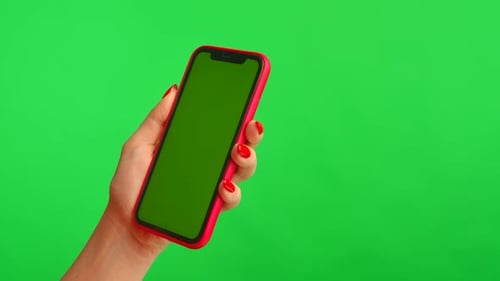 Woman Holds Mobile Phone with Workspace Mock Up Screen on Green Background