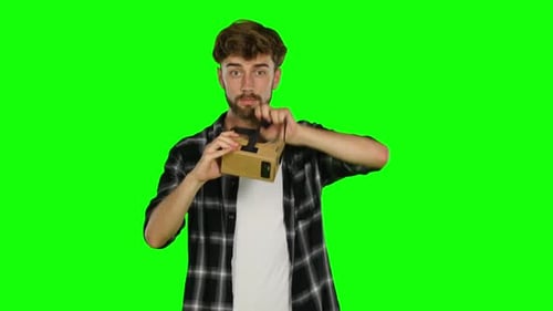 Man in Virtual Reality Is Smilling and It Makes Him Laughing. Green Screen