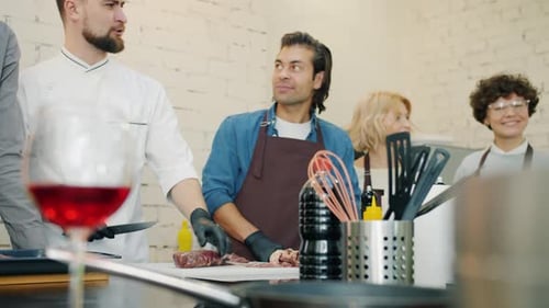 Adults Attending a Cheerful Cooking Class Indoors