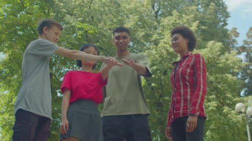 Positive Diverse Multiethnic Young People Stacking Hands Outdoors
