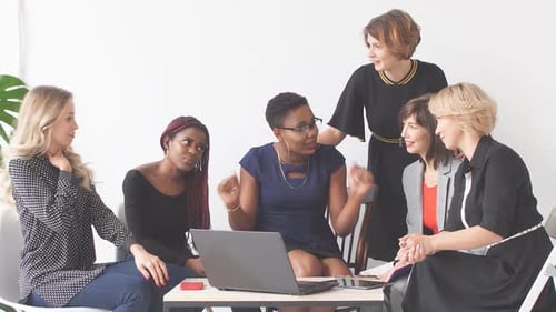 Six Women Collaborating at a Table in Office
