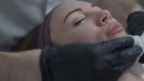 Closeup Cleansing of Beautiful Female Face in Beauty Parlor Spa