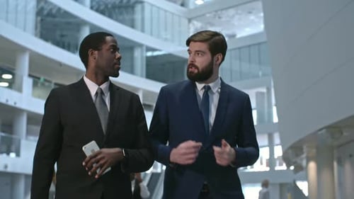 Businessmen Discussing Business in Modern Office Building