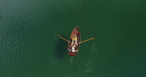 Young Couple In A Boat On The Background Of A Lake