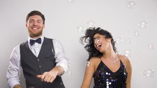 Happy Couple Dancing in Bubbles Celebration