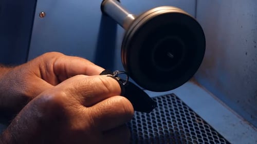 Goldsmith polishing ring in workshop
