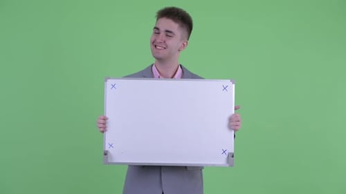 Smiling Man Holding Up a Blank Whiteboard