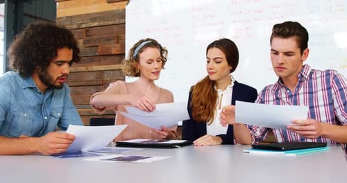 Team Reviewing Documents in a Modern Office