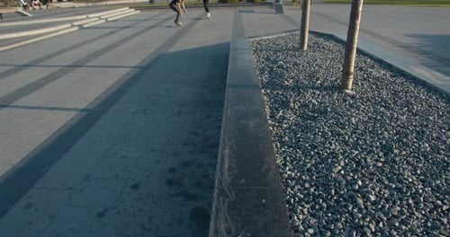 Skateboarders Are Doing a Rail Slide and One of Them Falls,