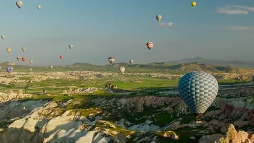 4K Aerial view of Goreme. Colorful hot air balloons fly over the valleys.