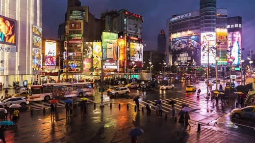 day to night time lapse of crosswalk at Ximending with falling rain in Taipei, Taiwan