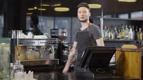 Cheerful Young Man Behind Modern Coffee Shop Bar