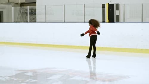 Girl Ice Skating on Indoor Rink