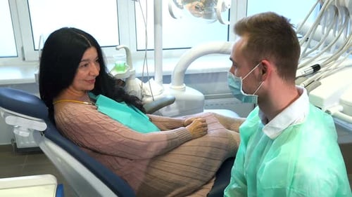Woman With Dentist Gives a Thumbs Up