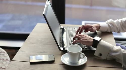 Typing on Laptop in Urban Workspace