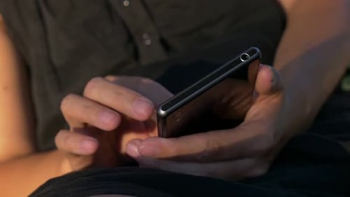 Person Holding and Using a Smartphone