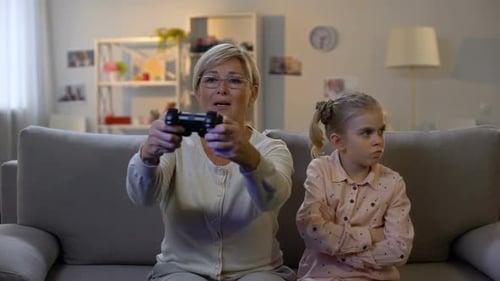 Grandmother and Granddaughter Playing Video Games at Home