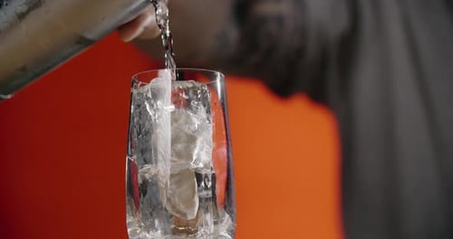 Iced Beverage Being Poured from Shaker